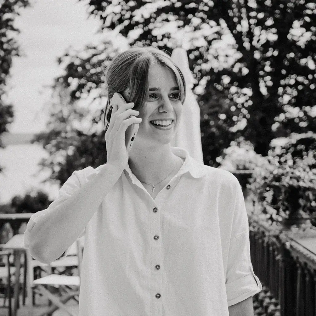 Ann-Kathrin Spöri lächelt und telefoniert mit einer Kundin